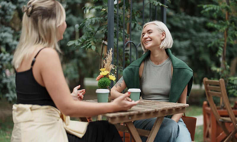 Two friends talking over coffee