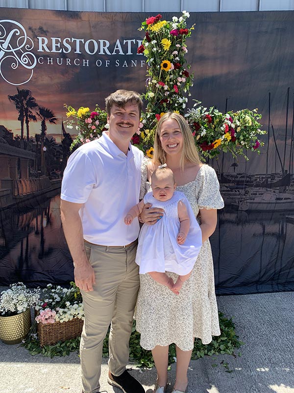 Family Standing in front of Easter Cross