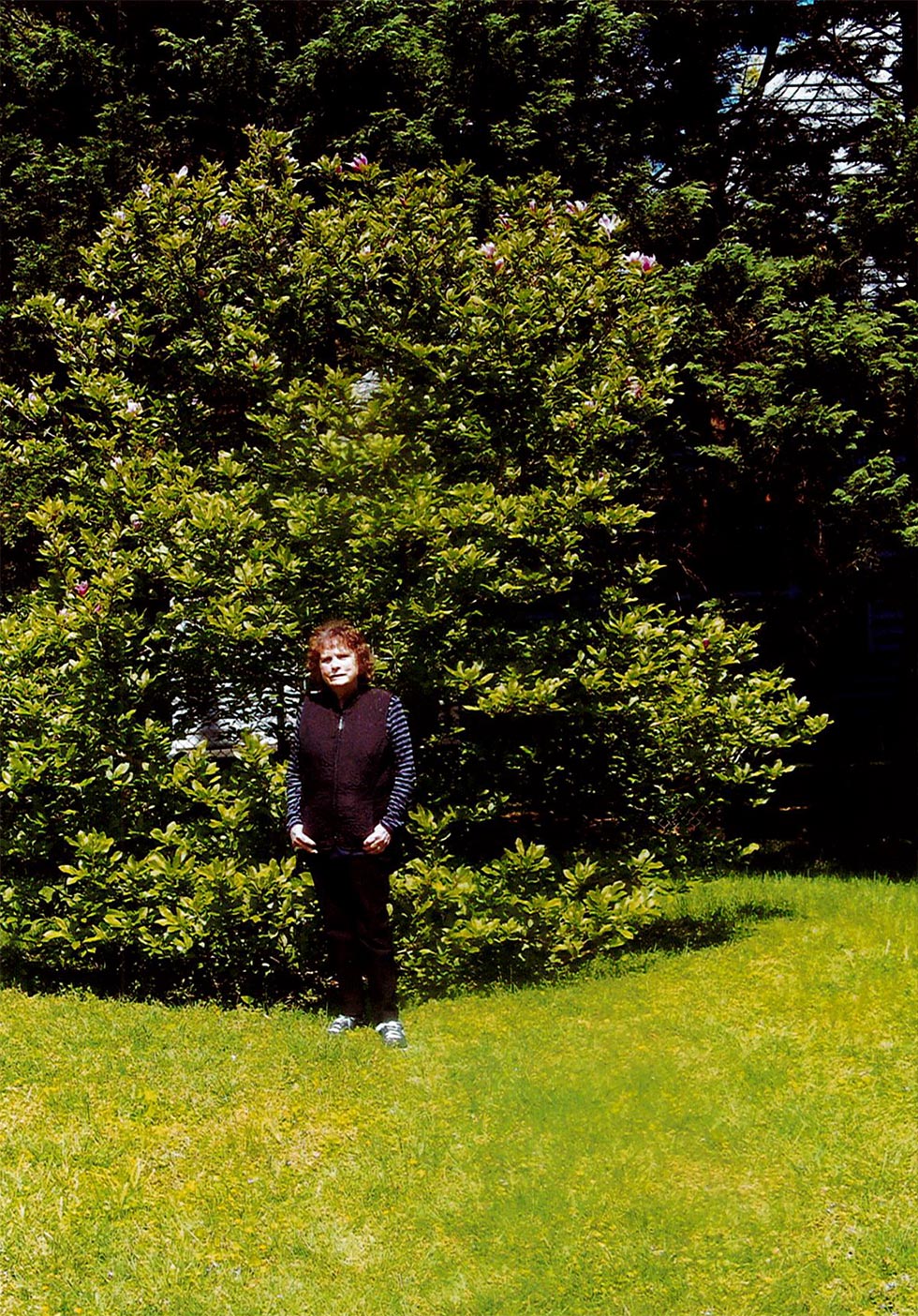 Lady Standing in front of large magnolia ann tree