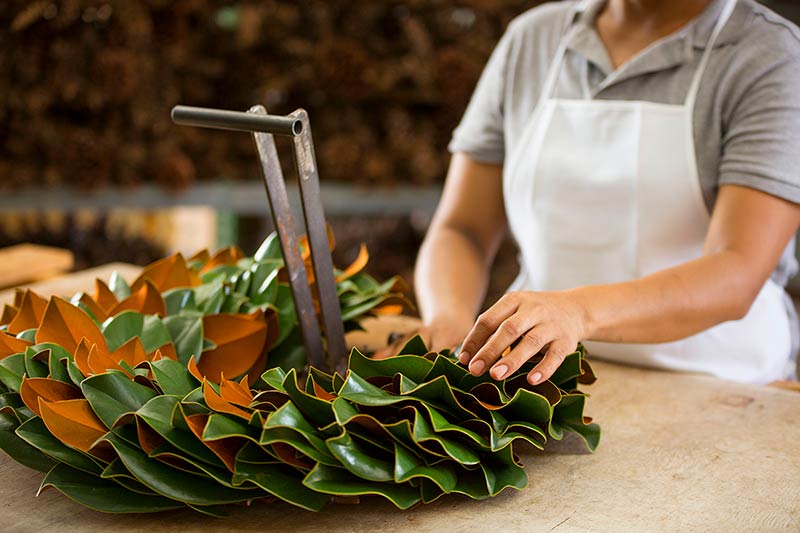 Artisan making fresh magnolia wreath